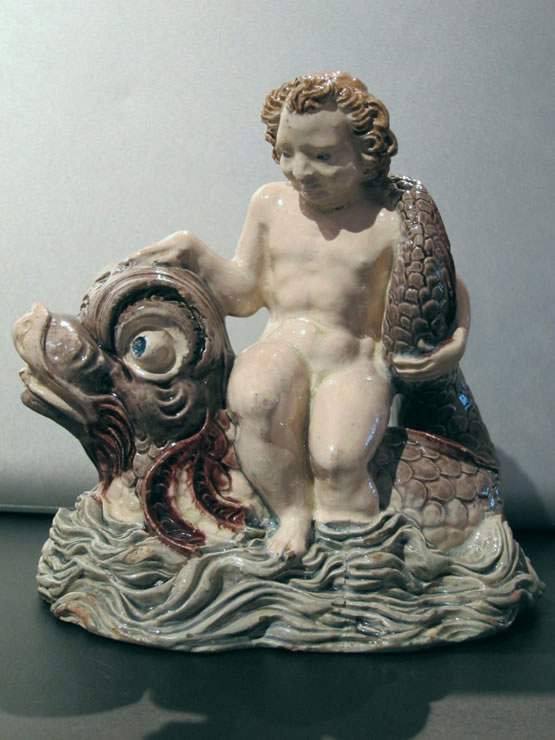 Fontainebleau glazed figure of a boy on a dolphin