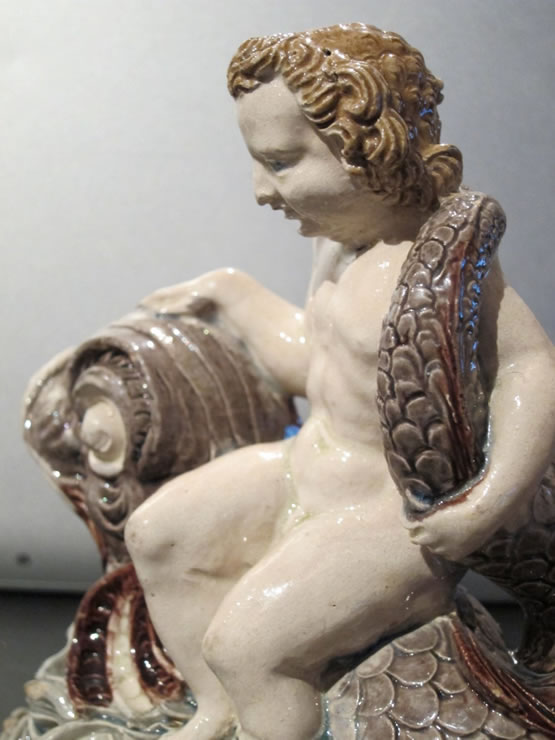 Fontainebleau glazed figure of a boy on a dolphin