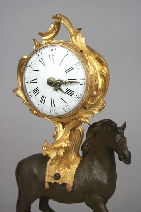 Early Louis XV clock supported by a horse.