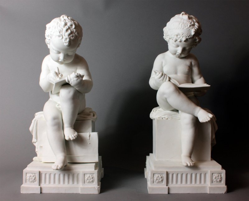 Dihl and Gurard biscuit figures depicting a boy reading and a girl writing.