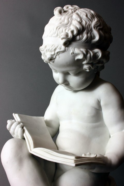 Dihl and Gurard biscuit figures depicting a boy reading and a girl writing.