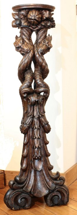Italian baroque walnut pedestals symbolizing the Agathodaemon