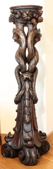 Italian baroque walnut pedestals symbolizing the Agathodaemon