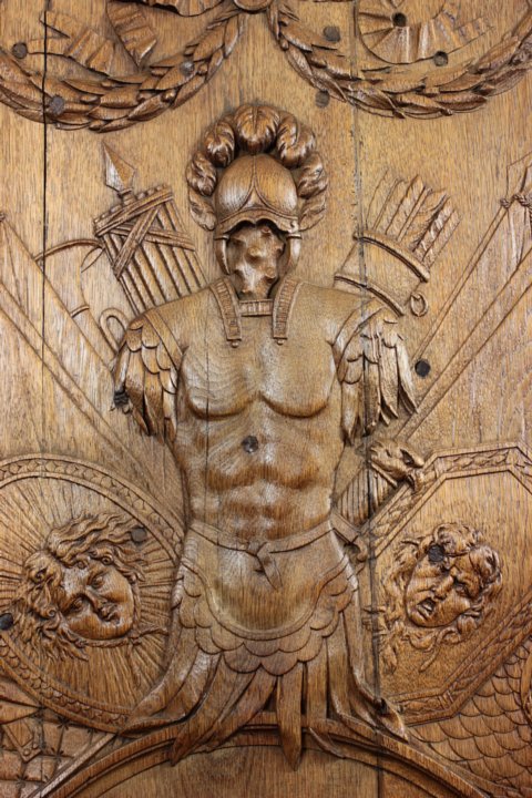 Neoclassical oak boiserie panel with military trophy